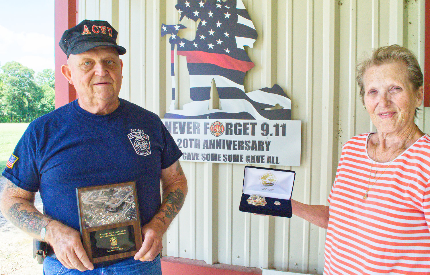Nelson and Diane Eaton of Lake Fork with his commemorative plaque, badge and pin for his service with the Arlington County, Virginia fire service following the Sept. 11, 2001 terrorist attack on the Pentagon. He recently installed the 20th anniversary memorial at their home.